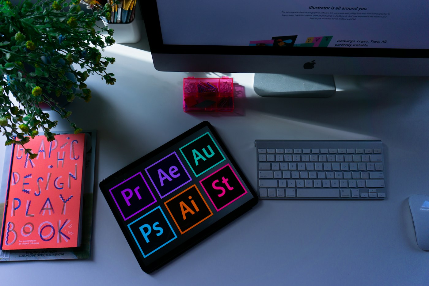 A designer's desk with colour swatches, a tablet and drawing tools
